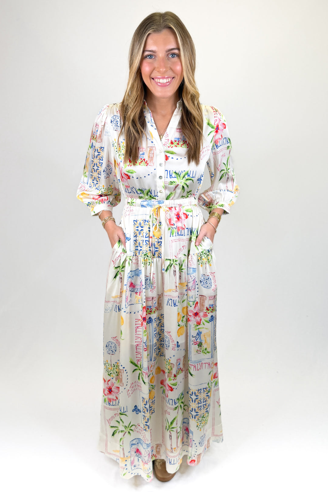 Woman wearing a beach printed, silky maxi dress.