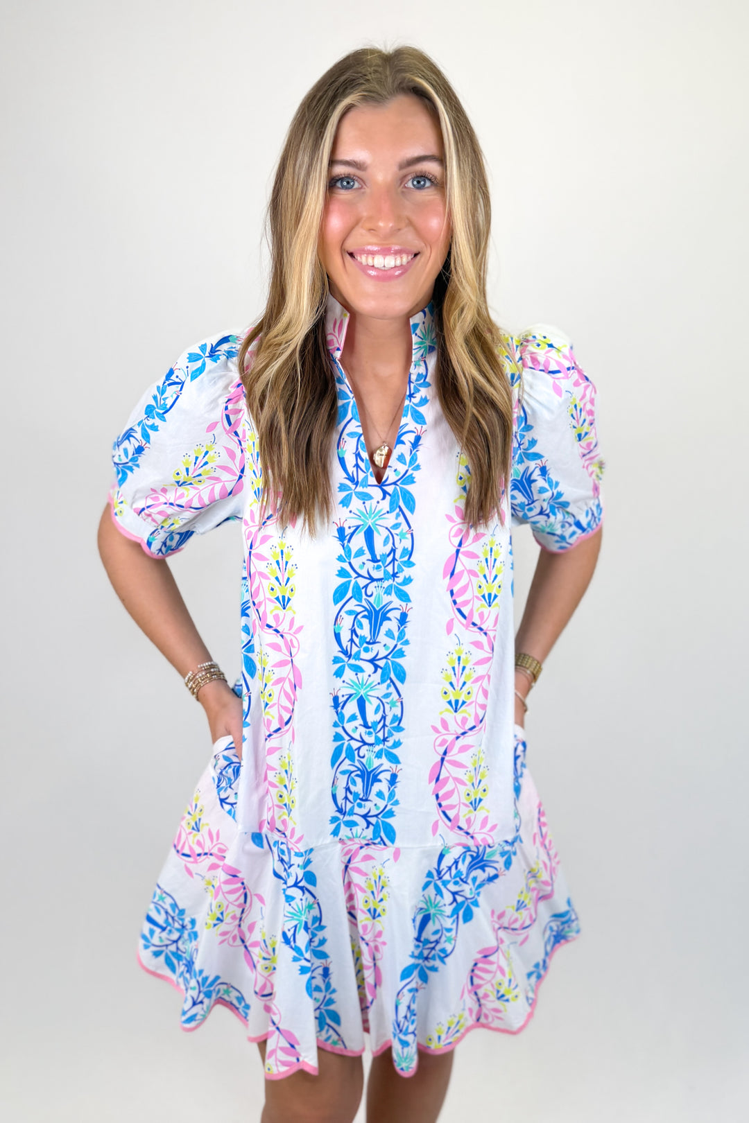 Woman wearing a colorful floral printed dress.