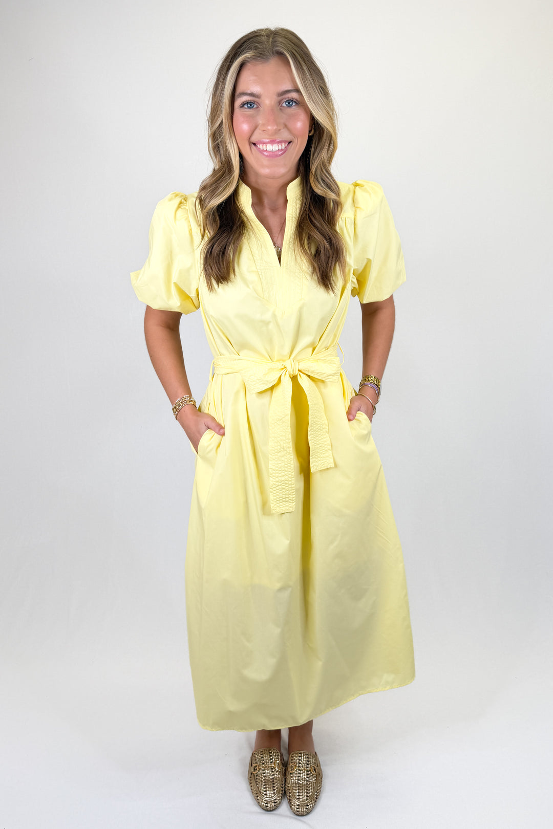Yellow puff sleeve midi dress with tie waist belt, split neckline, and side pockets