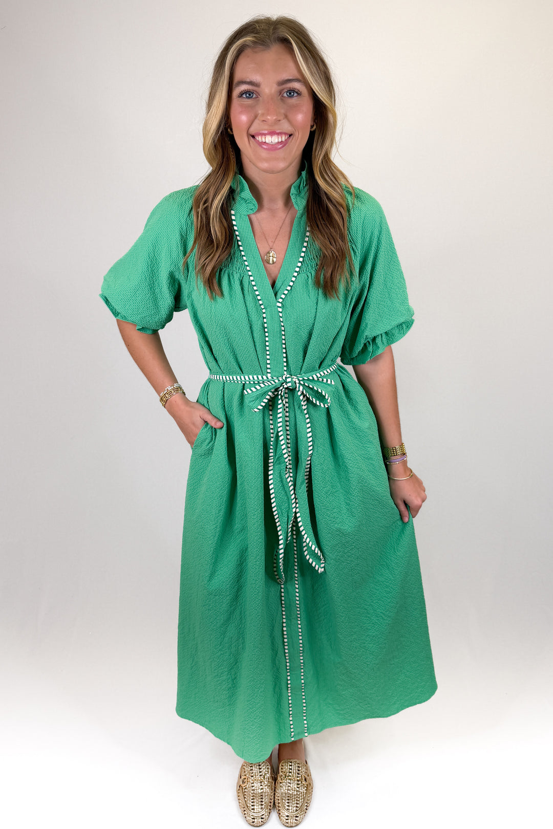 Green midi dress with white contrast trim and tie waist belt, short sleeve textured dress with pockets and stand collar, classic spring statement dress