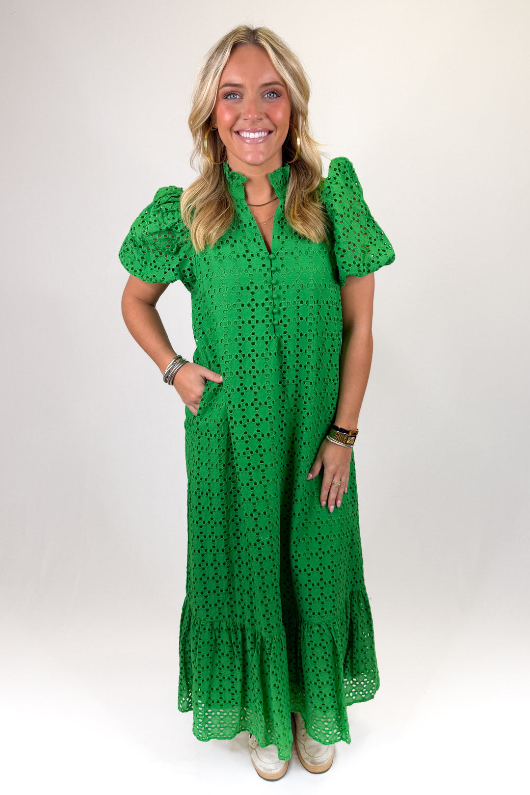 Green eyelet lace midi dress with puff sleeves, button-front detail, and tiered ruffle hem