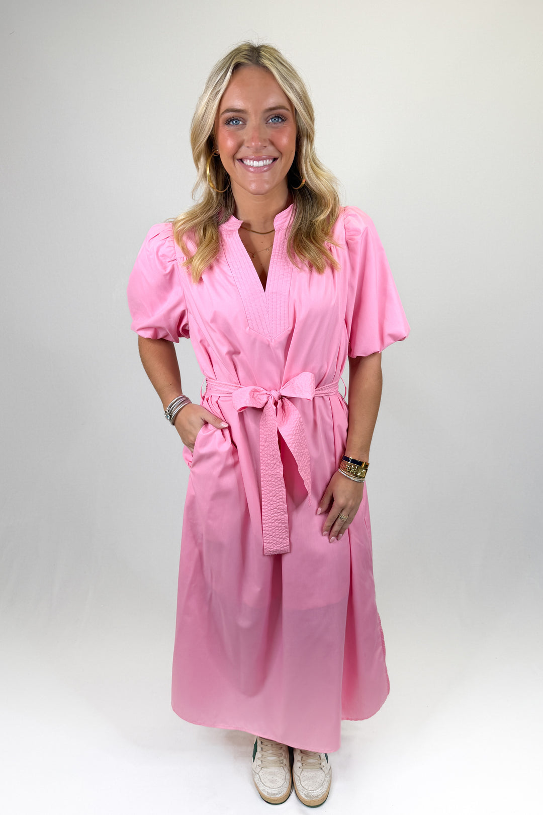 Pink puff sleeve midi dress with tie waist belt, split neckline, and side pockets