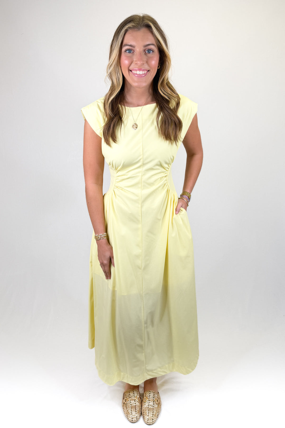Yellow cap sleeve midi dress with fitted waist detail, round neckline, and elegant A-line skirt