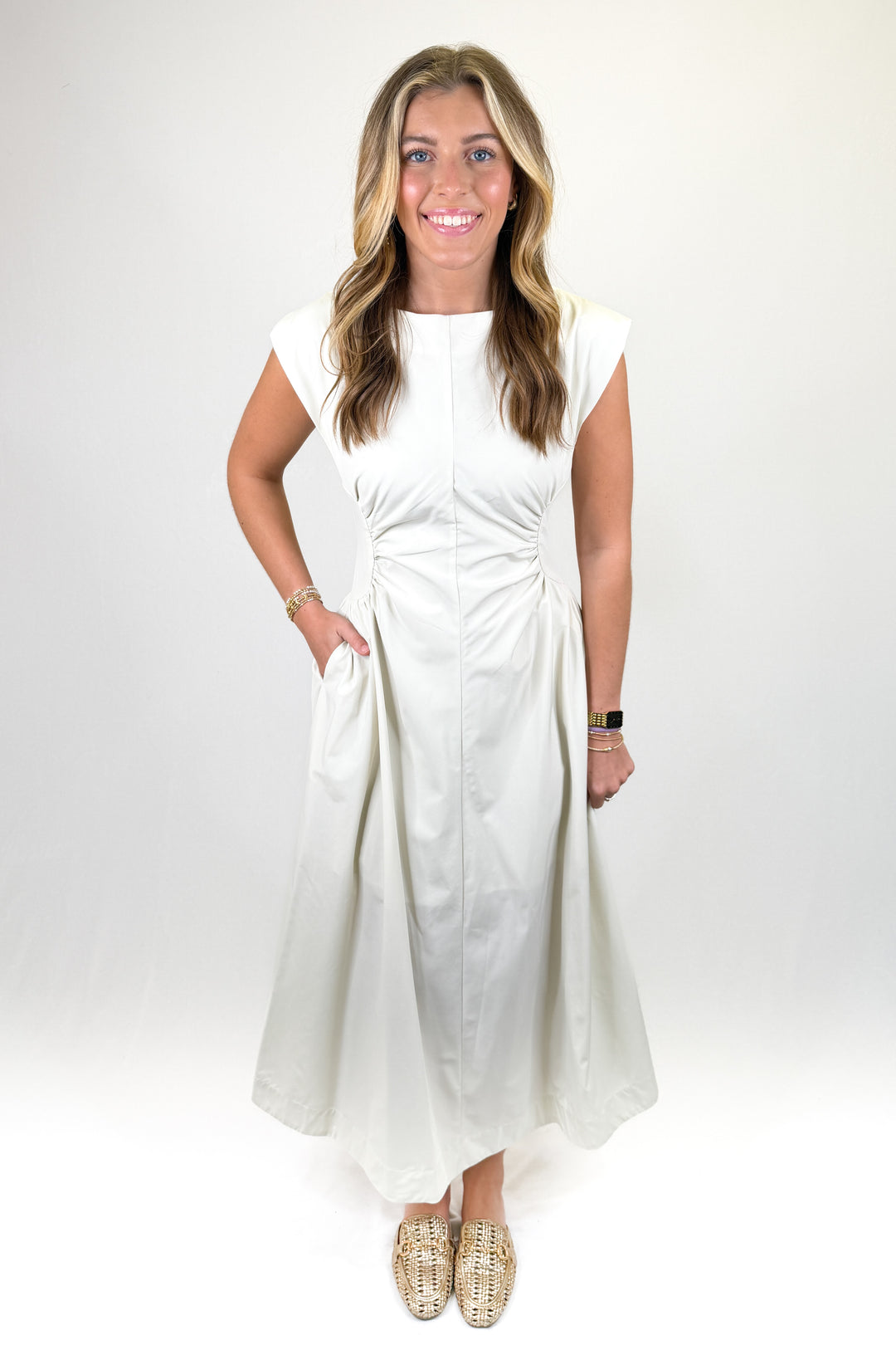 White cap sleeve midi dress with fitted waist detail, round neckline, and elegant A-line skirt