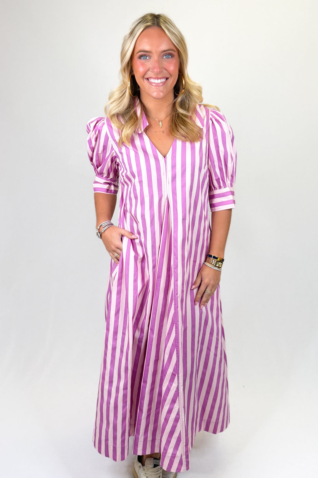 Pink and white striped women’s midi dress with puff sleeves, button front, and collared neckline