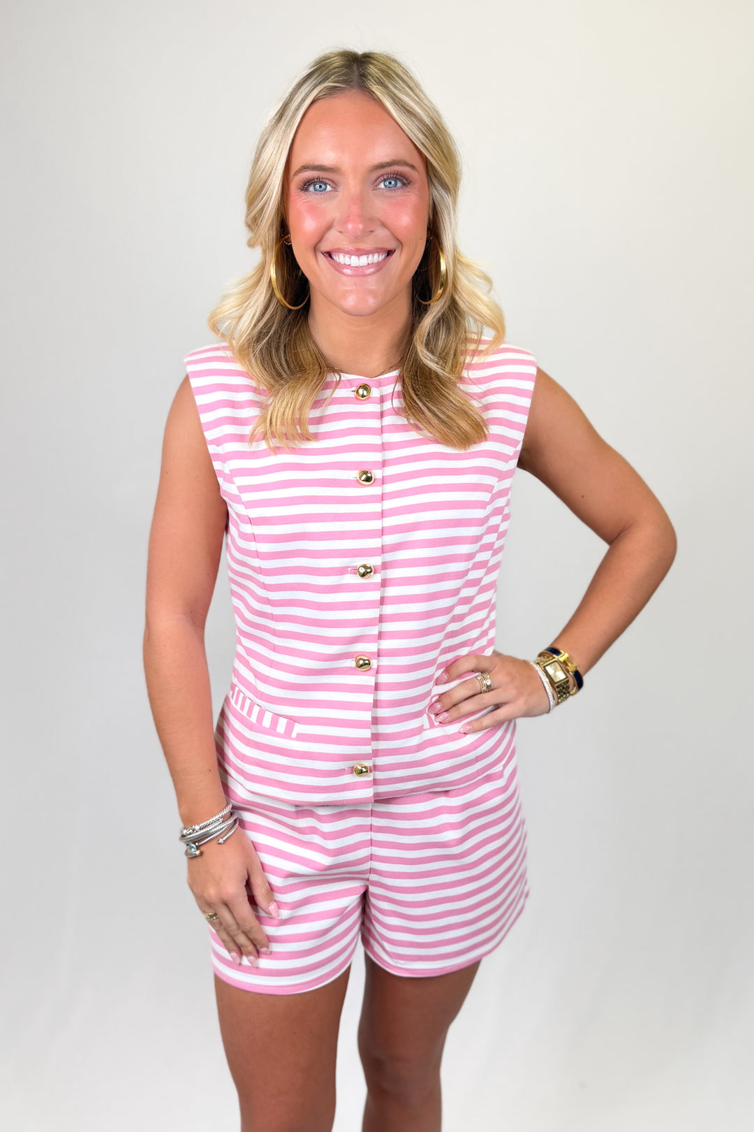 Pink and white striped women’s matching set with sleeveless button-front top and coordinating shorts