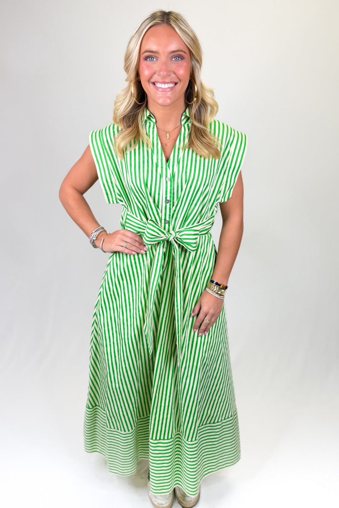 Green and white striped women’s maxi dress with button front, cap sleeves, and waist tie bow