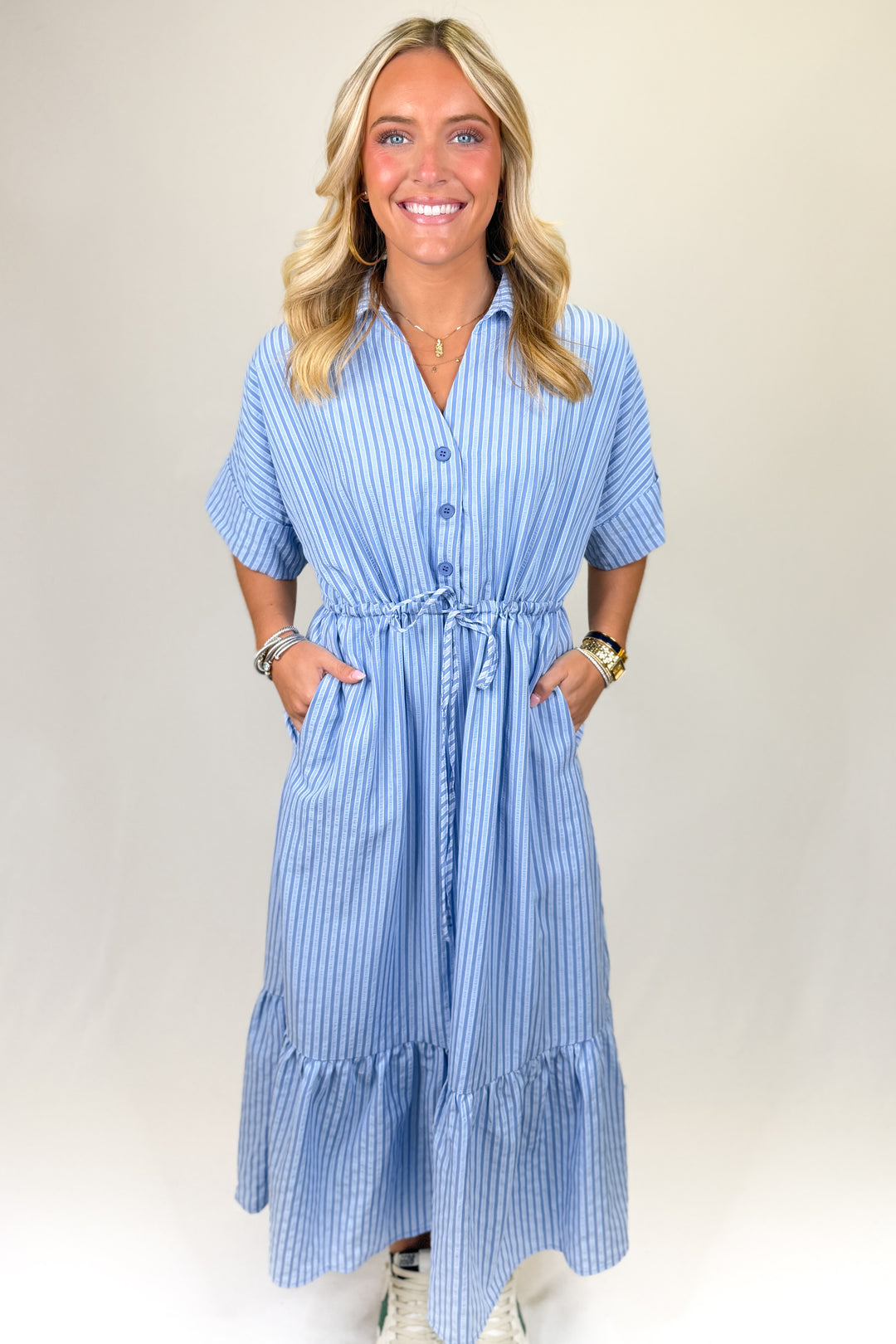 Blue and white striped women’s midi dress with button front, drawstring waist, and tiered ruffle hem