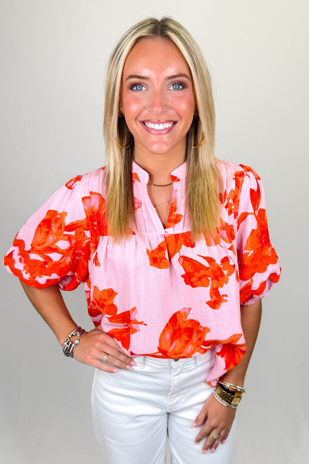 Boutique women’s pink and red floral print blouse with puff sleeves, lightweight fabric, and relaxed fit