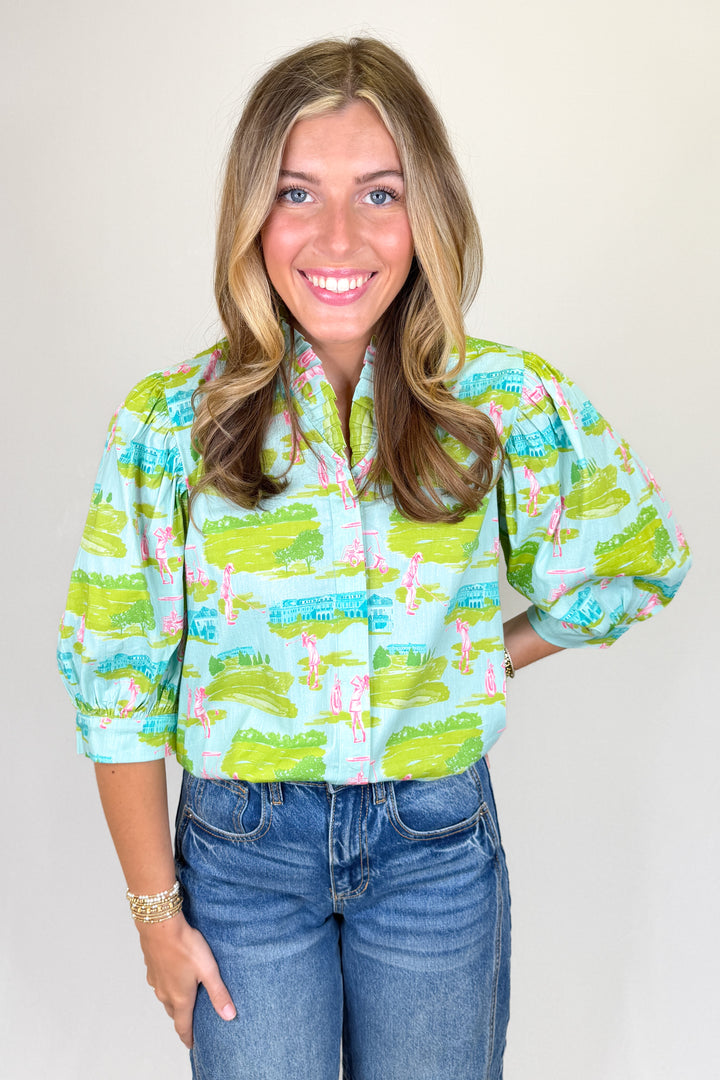 Green and pink scenic print blouse with puff sleeves and ruffle collar styled with denim jeans | Walker Boutique