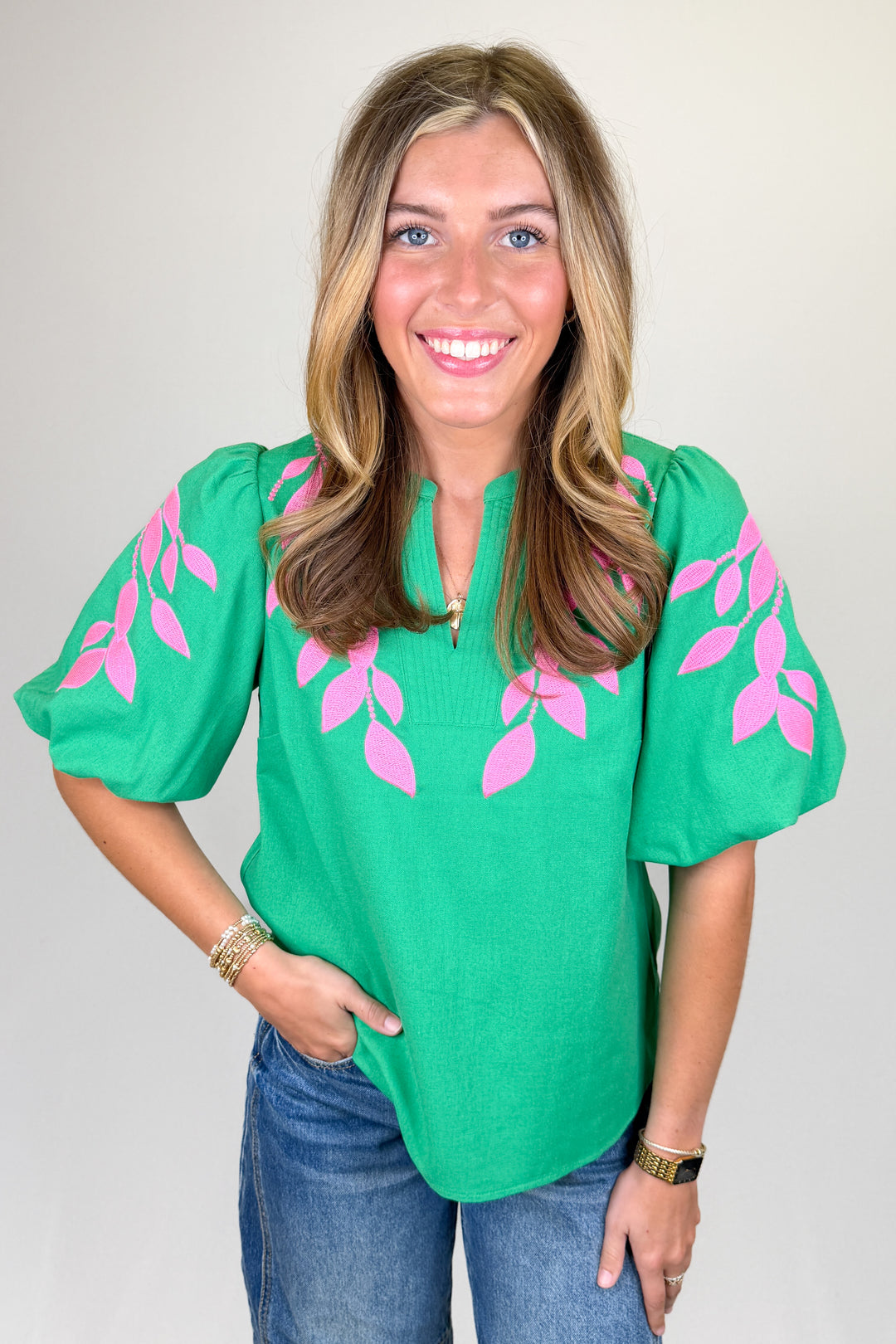 Boutique women’s green embroidered blouse with pink leaf detailing, puff sleeves, and lightweight fabric