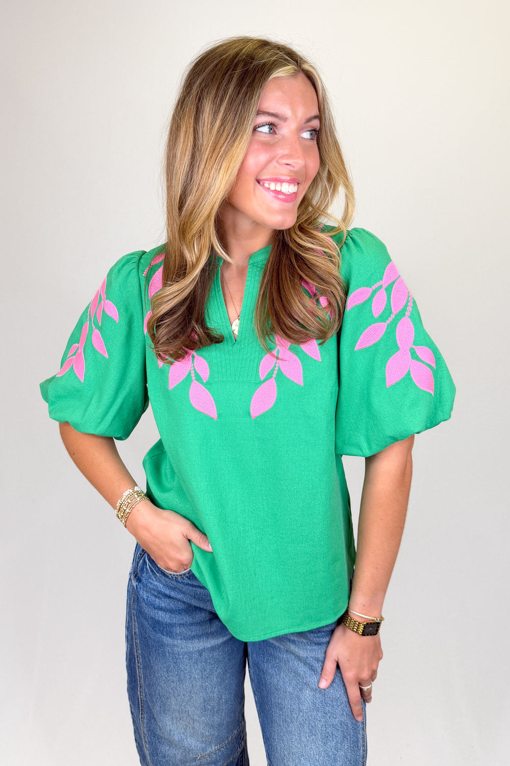 Boutique women’s green embroidered blouse with pink leaf detailing, puff sleeves, and lightweight fabric