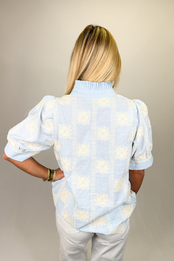 Boutique women’s blue gingham top with white lace embroidery, puff sleeves, and lightweight fabric