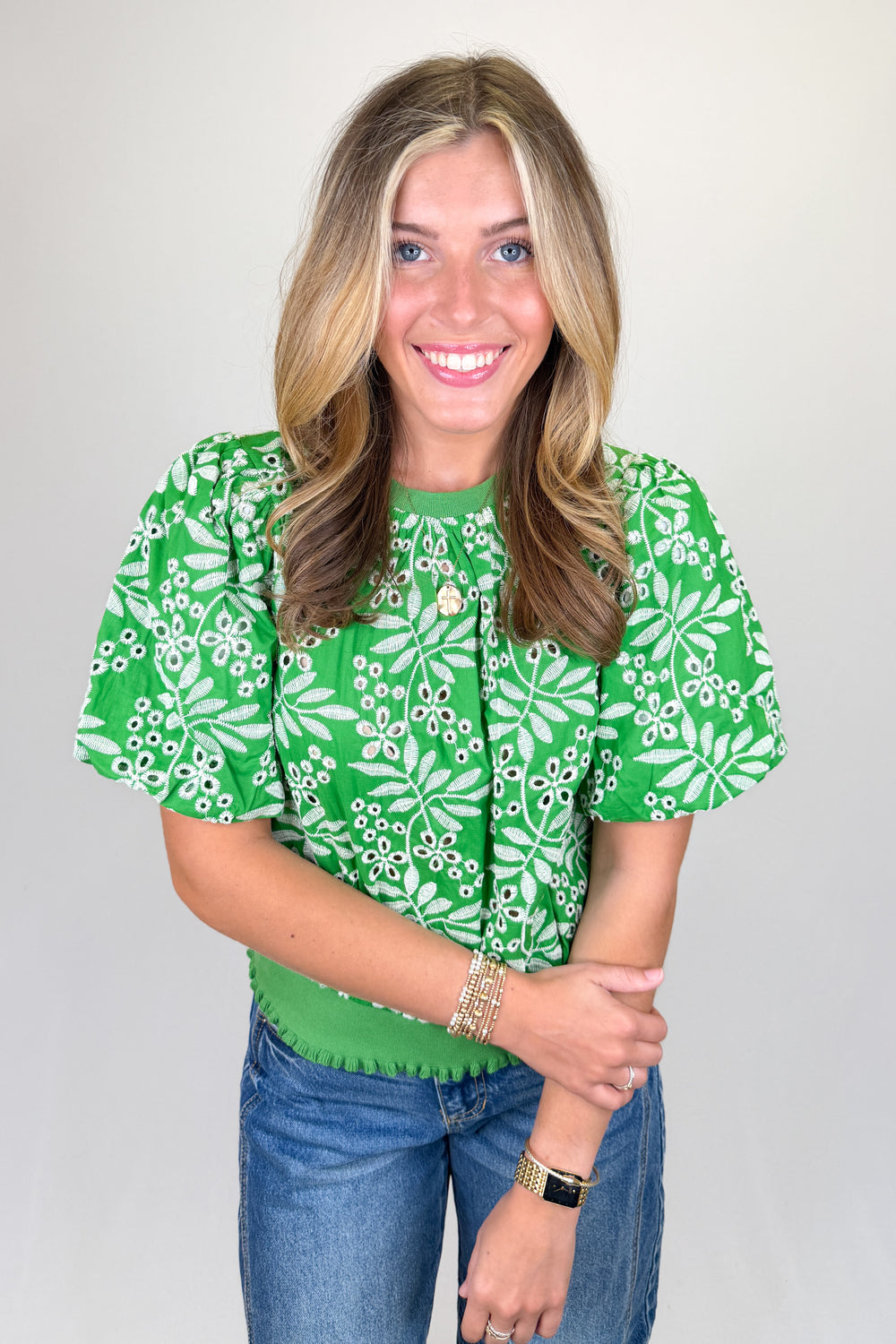 Boutique women’s green embroidered top with white floral pattern, puff sleeves, and textured detailing
