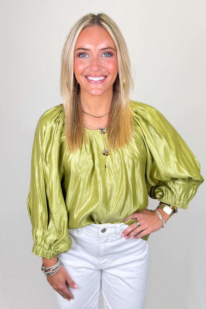 Boutique women’s olive green satin top with statement puff sleeves, button detail, and lightweight sheen fabric