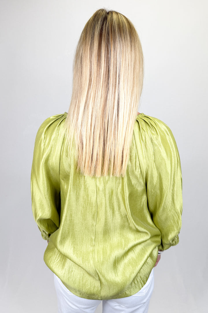 Boutique women’s olive green satin top with statement puff sleeves, button detail, and lightweight sheen fabric