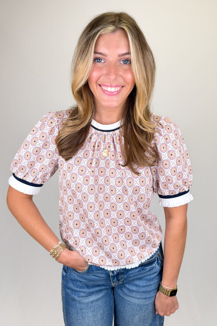 Boutique women’s pink and cream floral print blouse with puff sleeves, contrast neckline, and lightweight fabric