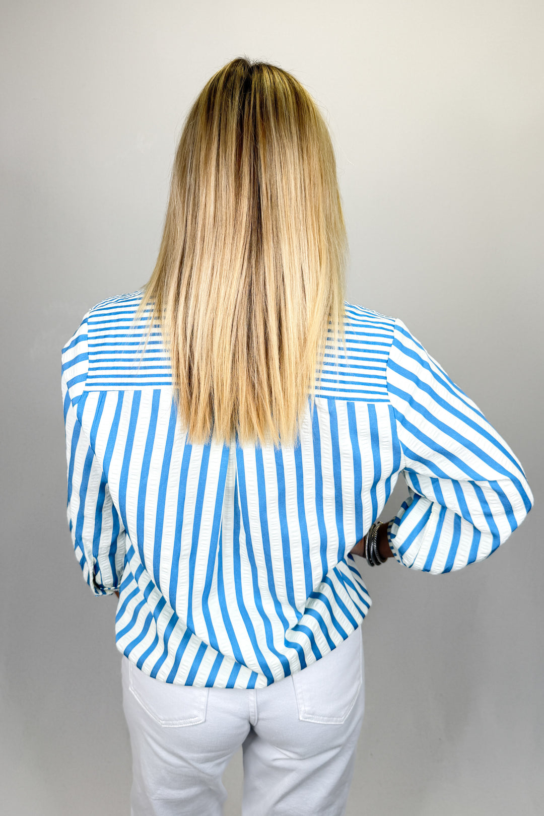 Boutique women’s blue and white striped top with collar detail, lightweight fabric, and relaxed fit