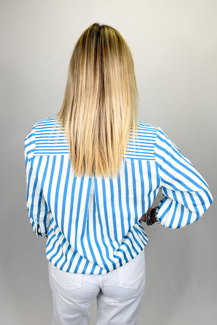 Boutique women’s blue and white striped top with collar detail, lightweight fabric, and relaxed fit