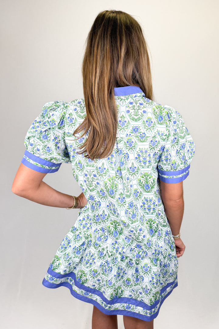 Boutique women’s floral print dress in white, blue, and green with contrast neckline, short sleeves, and flowy fit