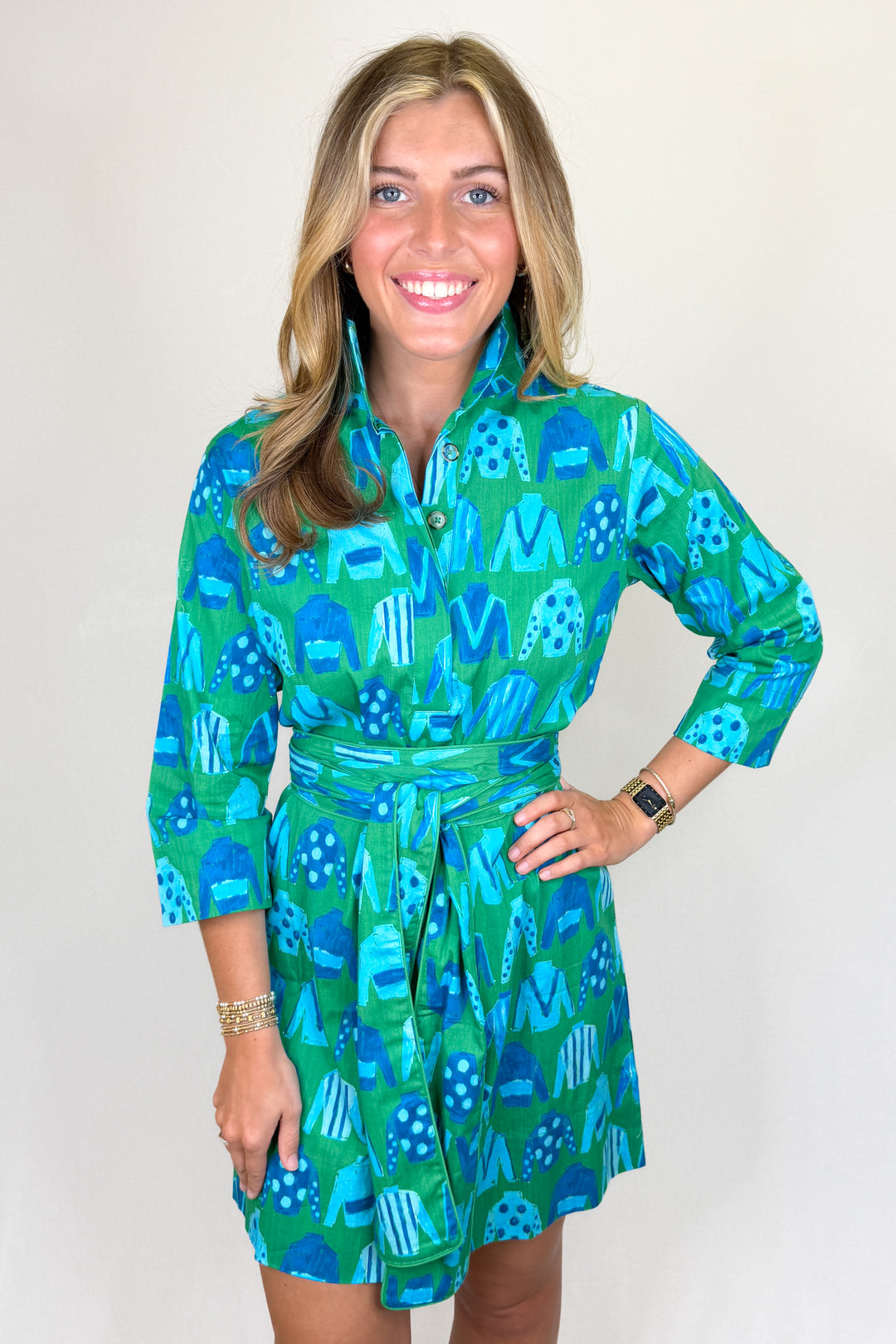 Boutique women’s green and blue patterned shirt dress with collared neckline, button front, and adjustable waist tie
