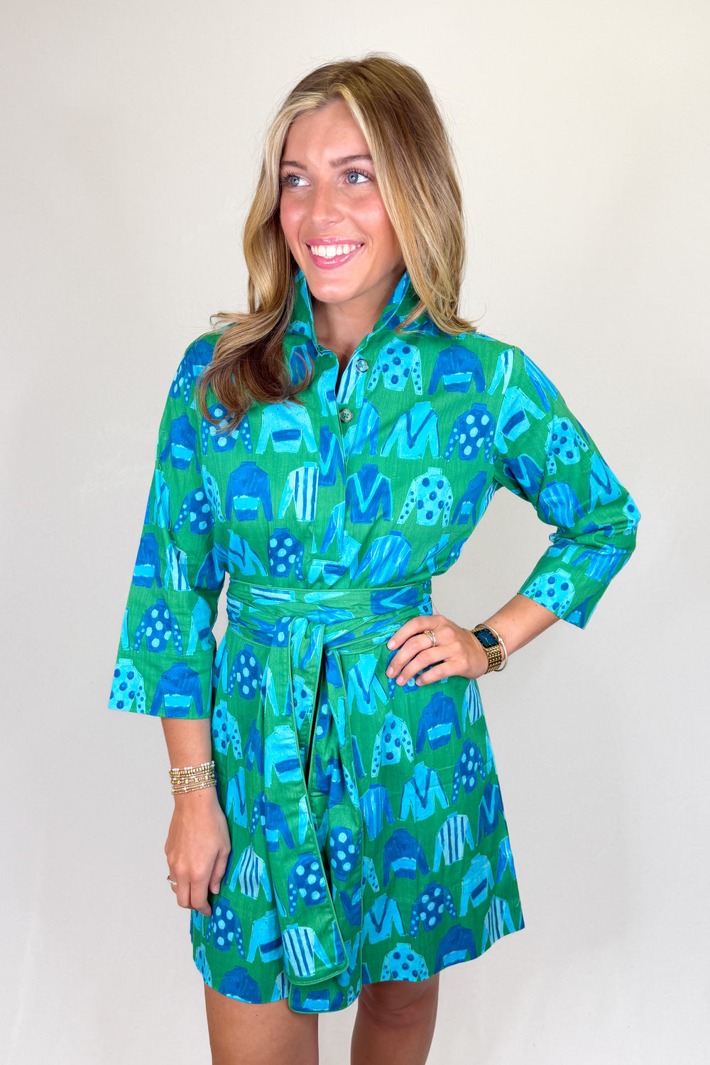 Boutique women’s green and blue patterned shirt dress with collared neckline, button front, and adjustable waist tie
