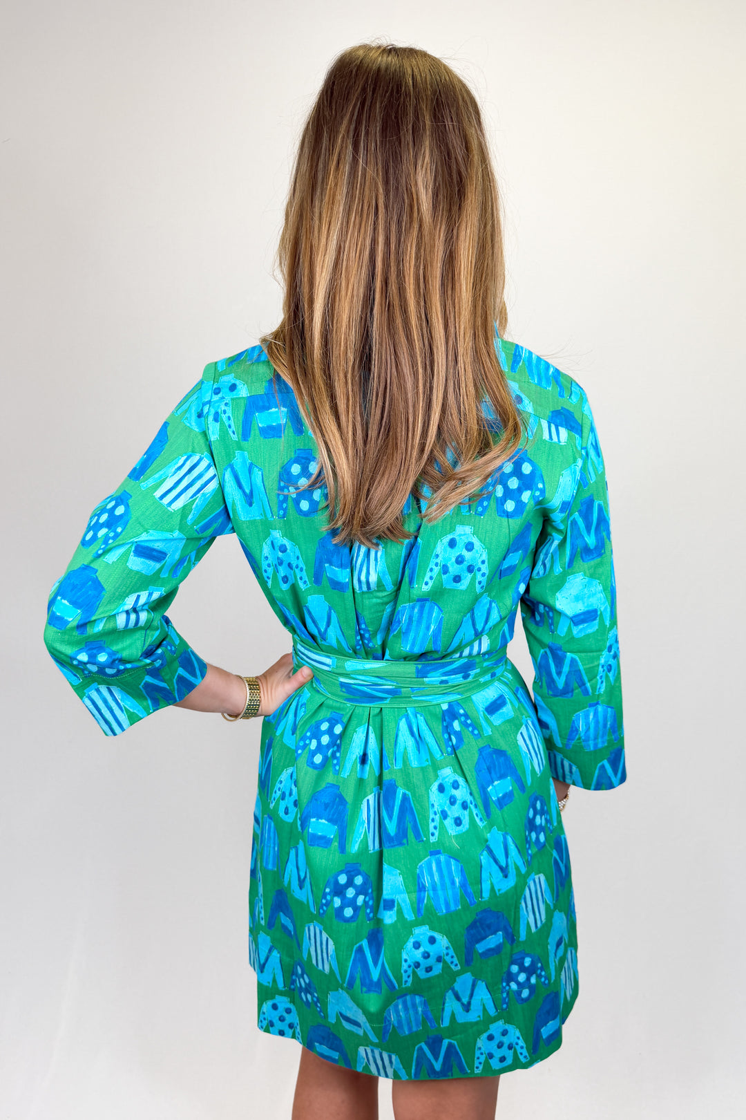 Boutique women’s green and blue patterned shirt dress with collared neckline, button front, and adjustable waist tie