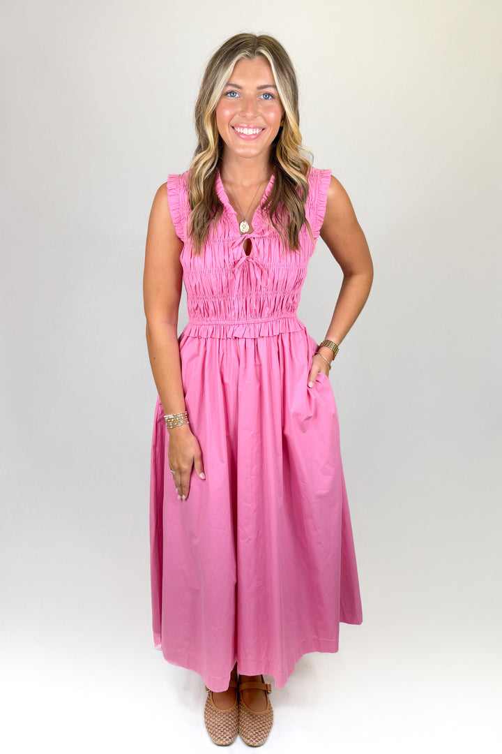Woman wearing a pink dress against a white background