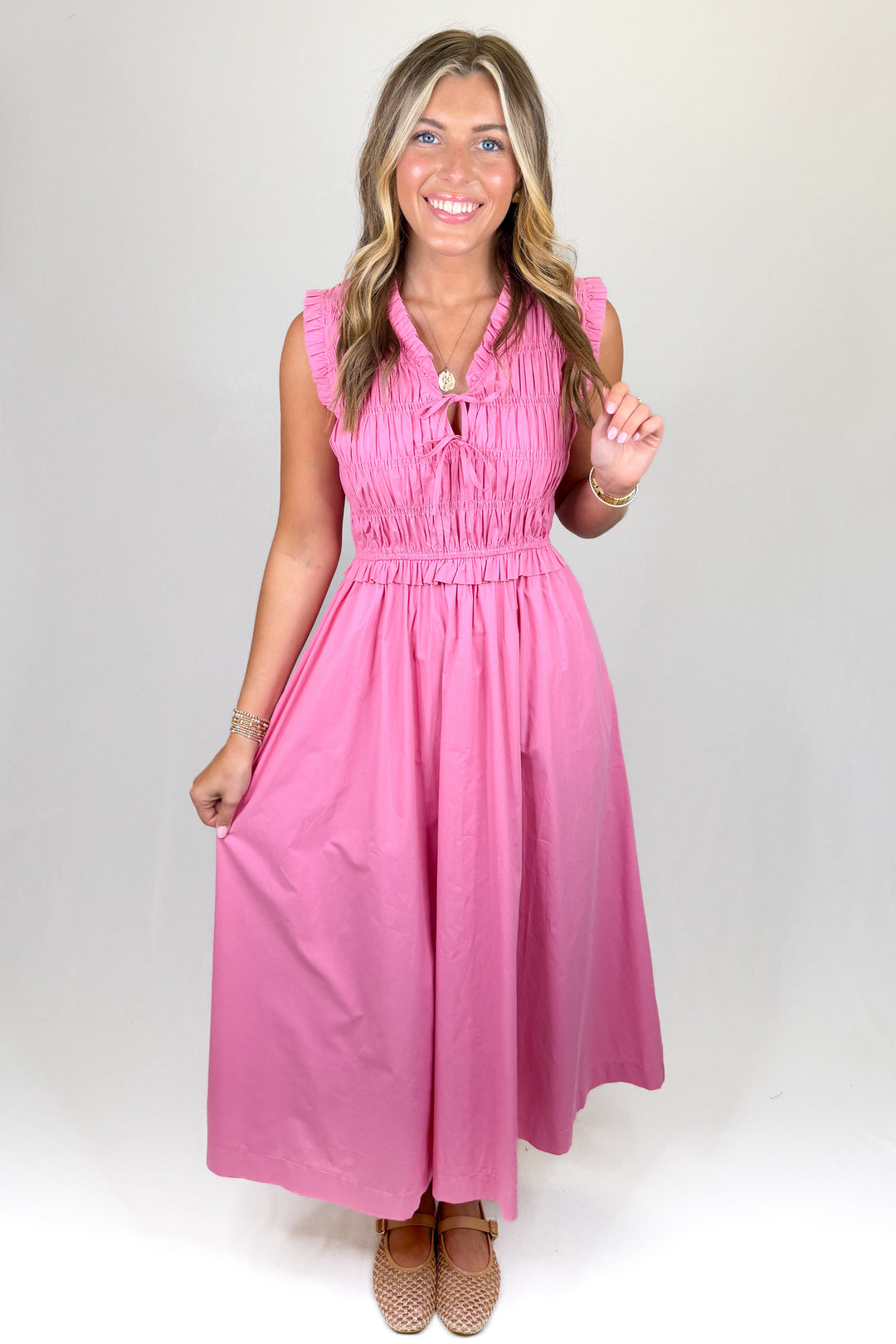 Woman wearing a pink dress against a white background