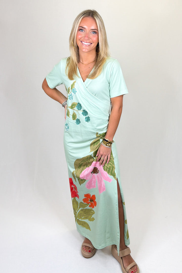 Mint green floral print maxi dress with short sleeves, wrap-style bodice, V-neckline, and straight skirt, featuring a lightweight feel and relaxed fit