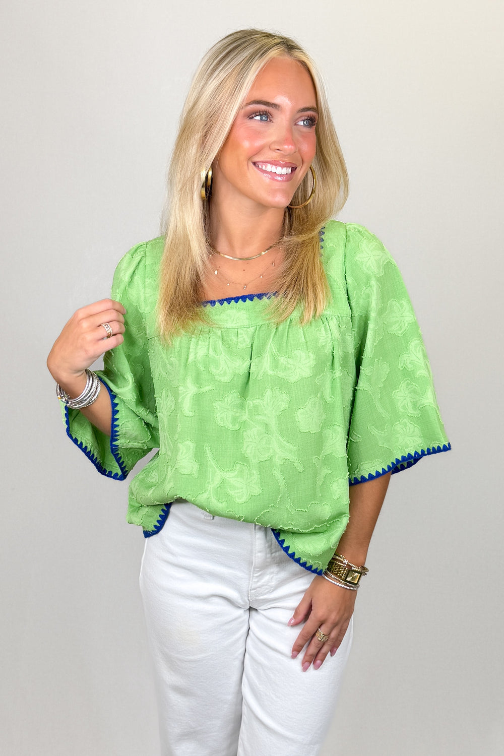 Green textured blouse with scalloped trim and short sleeves | Walker Boutique