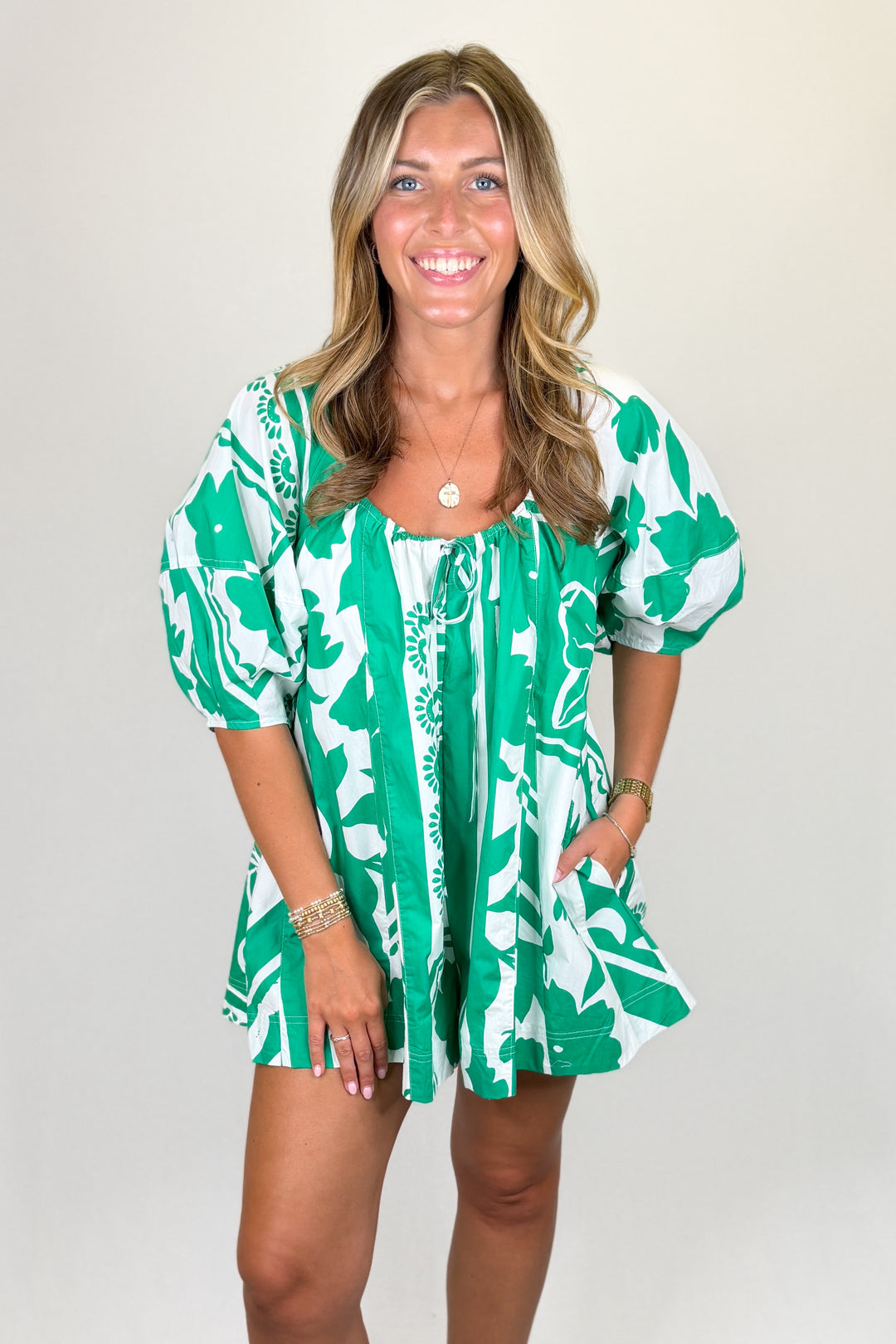 Green and white floral print mini dress with puff sleeves and tie neckline