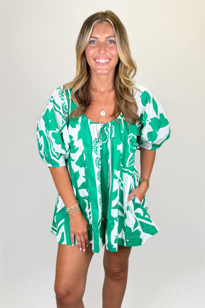 Green and white floral print mini dress with puff sleeves and tie neckline