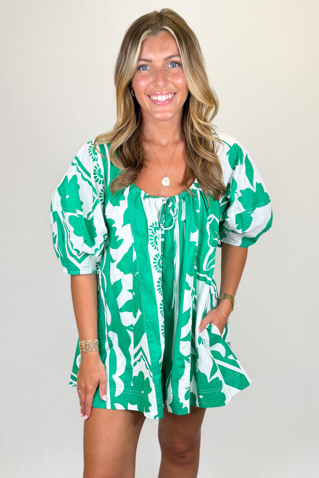 Green and white floral print mini dress with puff sleeves and tie neckline