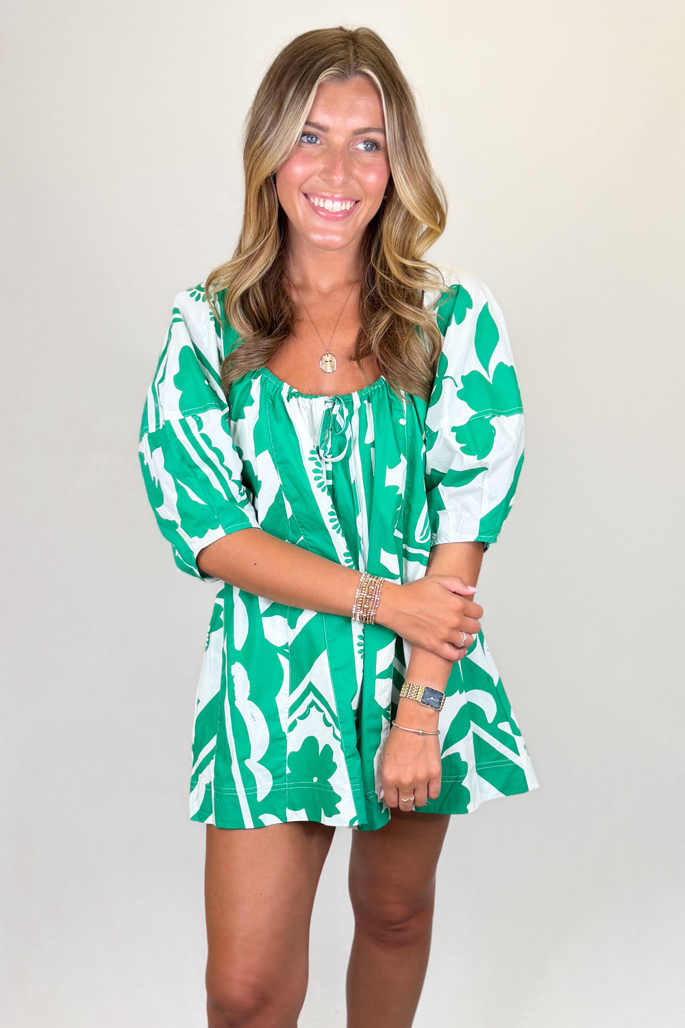 Green and white floral print mini dress with puff sleeves and tie neckline