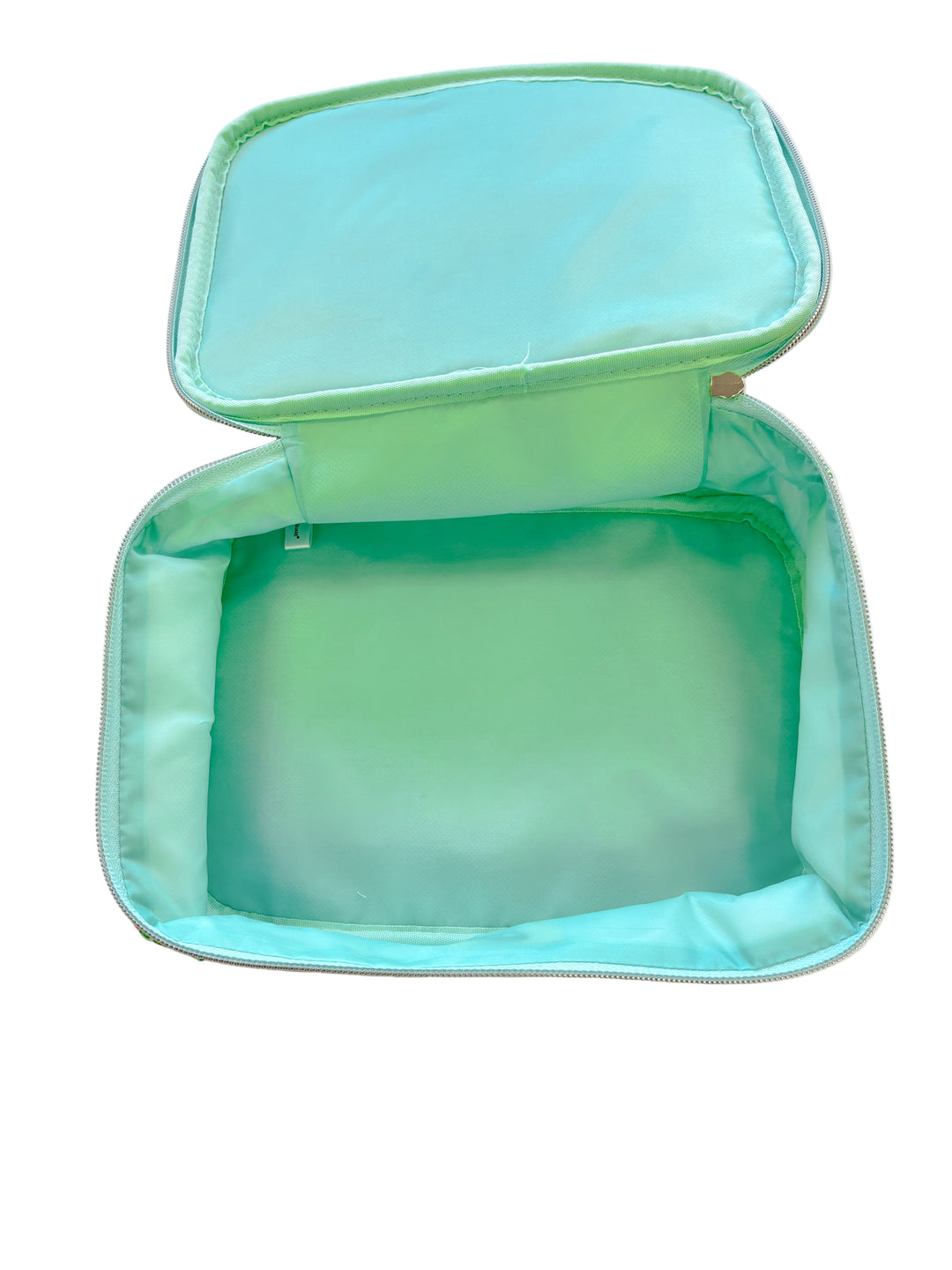 Interior view of cosmetic bag with spacious solid mint lining.