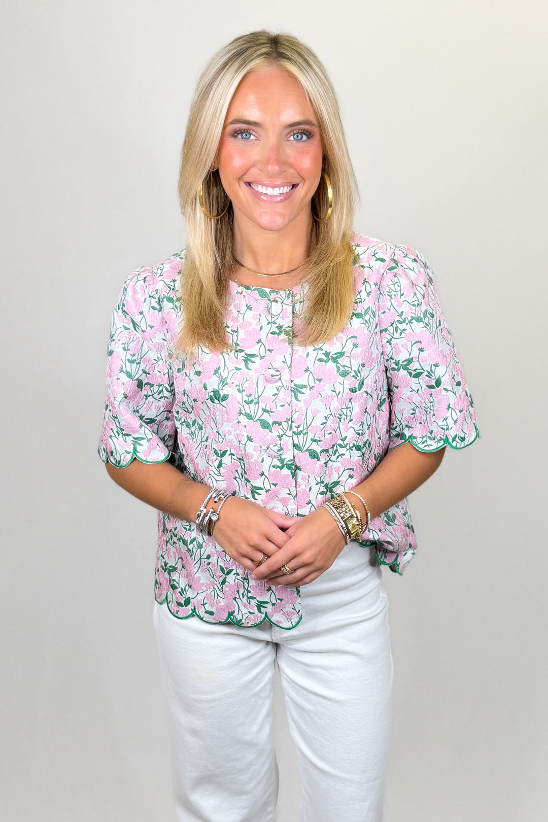 Pink floral blouse with green trim and scalloped hem short sleeve top | Walker Boutique