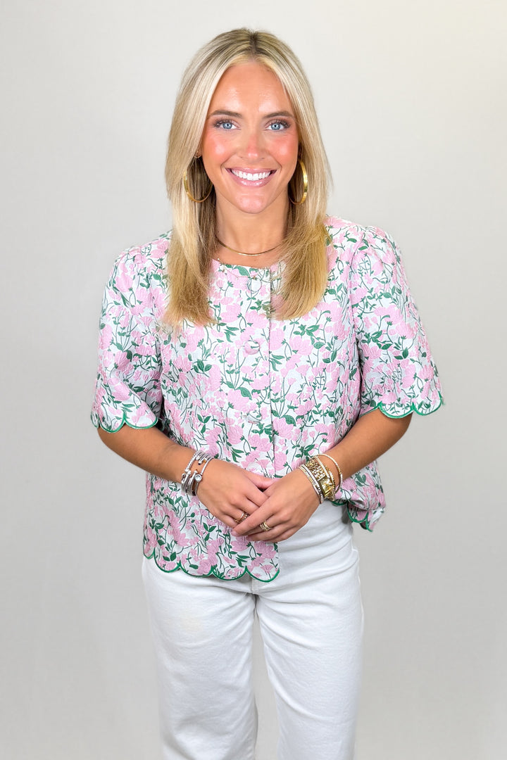 Pink floral blouse with green trim and scalloped hem short sleeve top | Walker Boutique