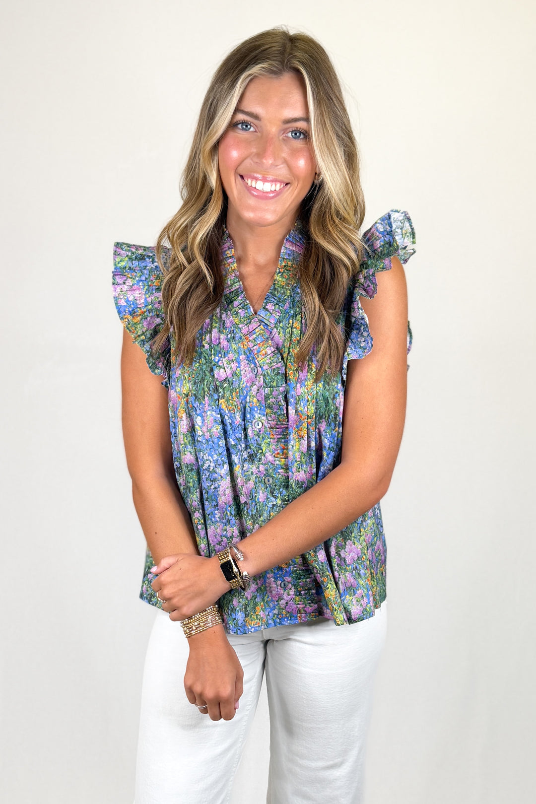 Multicolor floral sleeveless blouse with ruffle collar and flutter sleeves, lightweight women’s boutique top