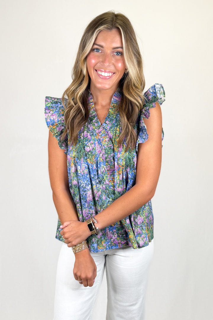 Multicolor floral sleeveless blouse with ruffle collar and flutter sleeves, lightweight women’s boutique top