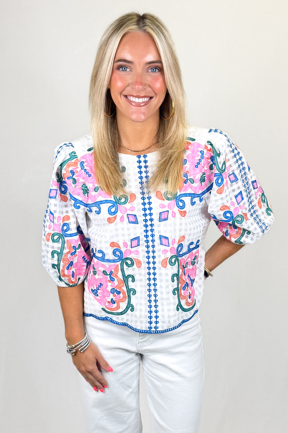 White embroidered blouse with pink and blue floral pattern, puff sleeves, lightweight women’s boutique top