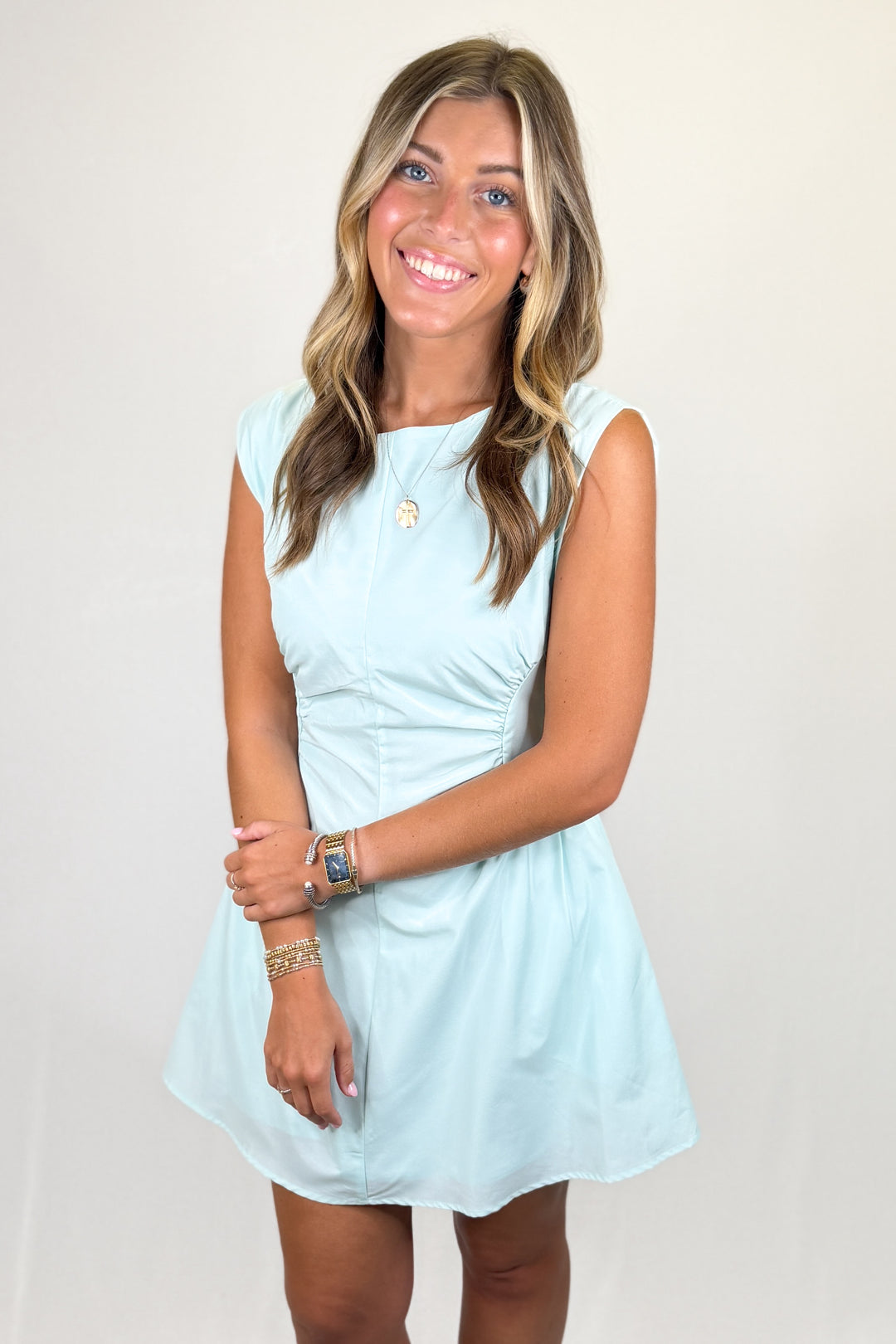 Light blue sleeveless mini dress with fitted bodice and flared skirt, classic women’s summer dress
