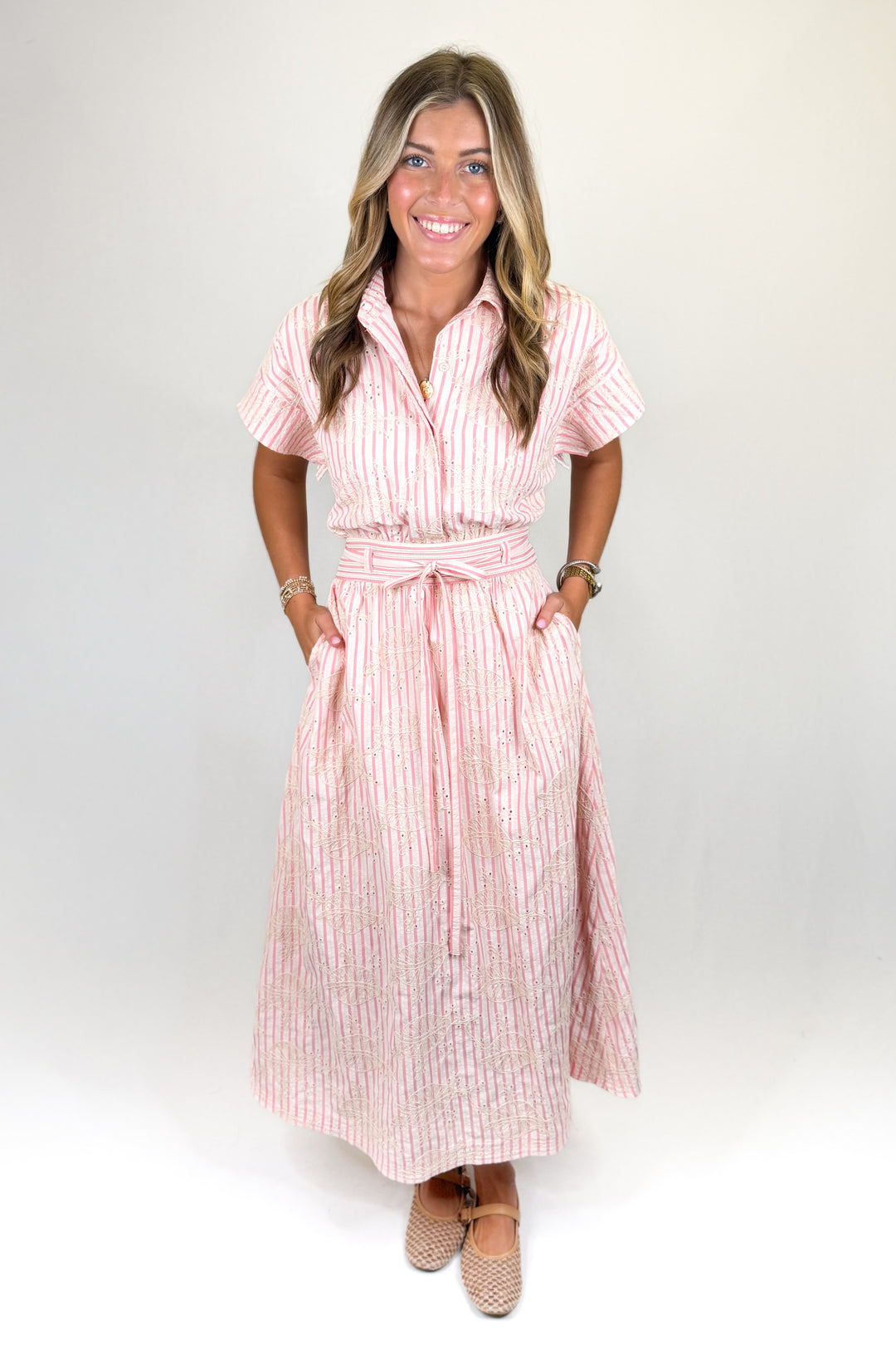 Pink striped midi shirt dress with short sleeves, button front, tie waist, and pockets, classic women’s dress