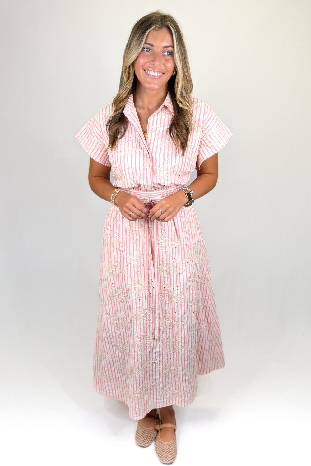 Pink striped midi shirt dress with short sleeves, button front, tie waist, and pockets, classic women’s dress