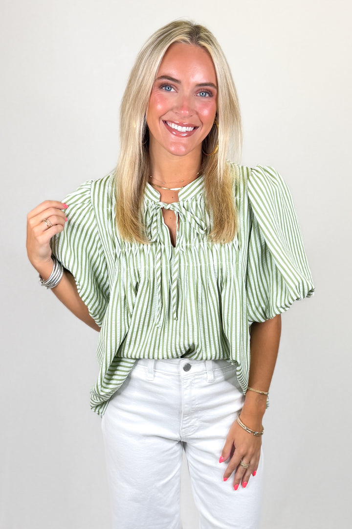 Green and white striped blouse with tie neckline and short sleeves