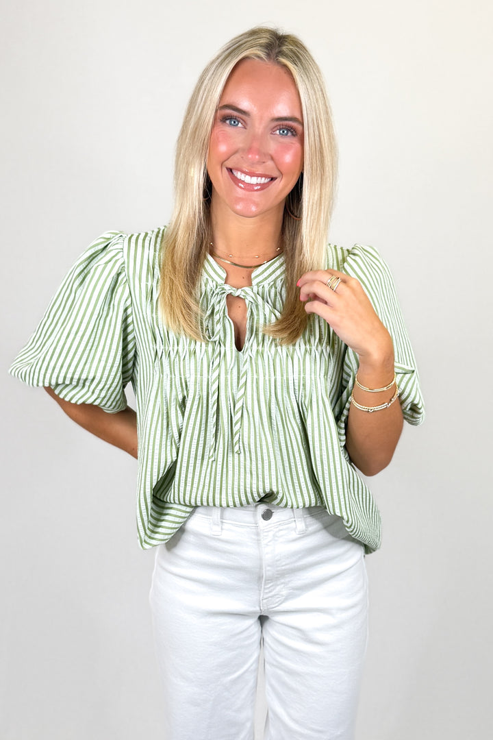 Green and white striped blouse with tie neckline and short sleeves