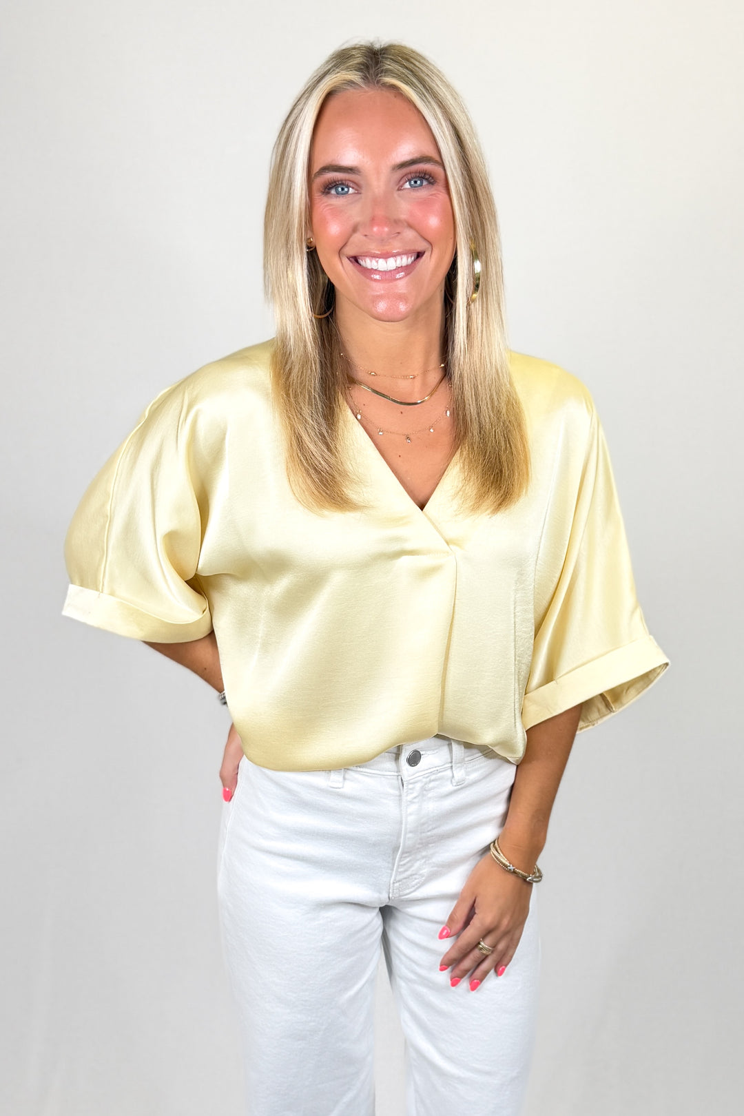 Butter yellow satin blouse with v-neckline and short sleeves