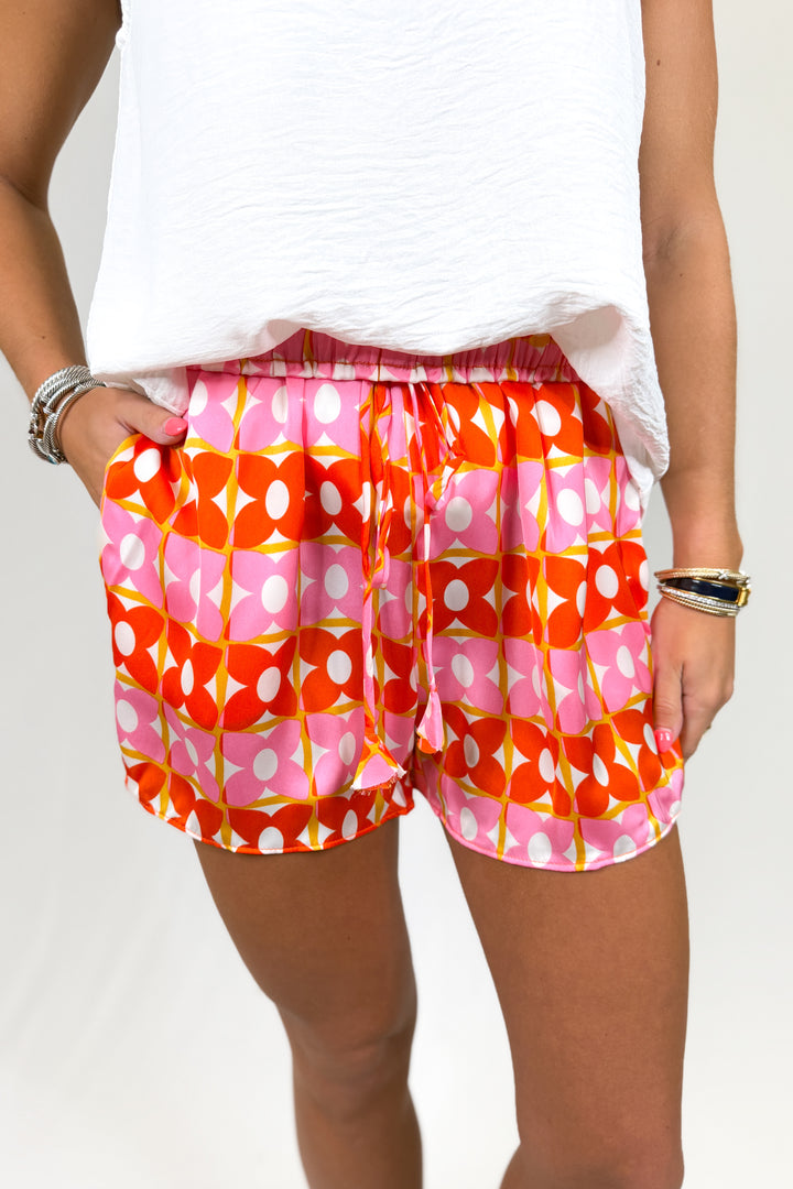 Person wearing colorful patterned shorts on a white background