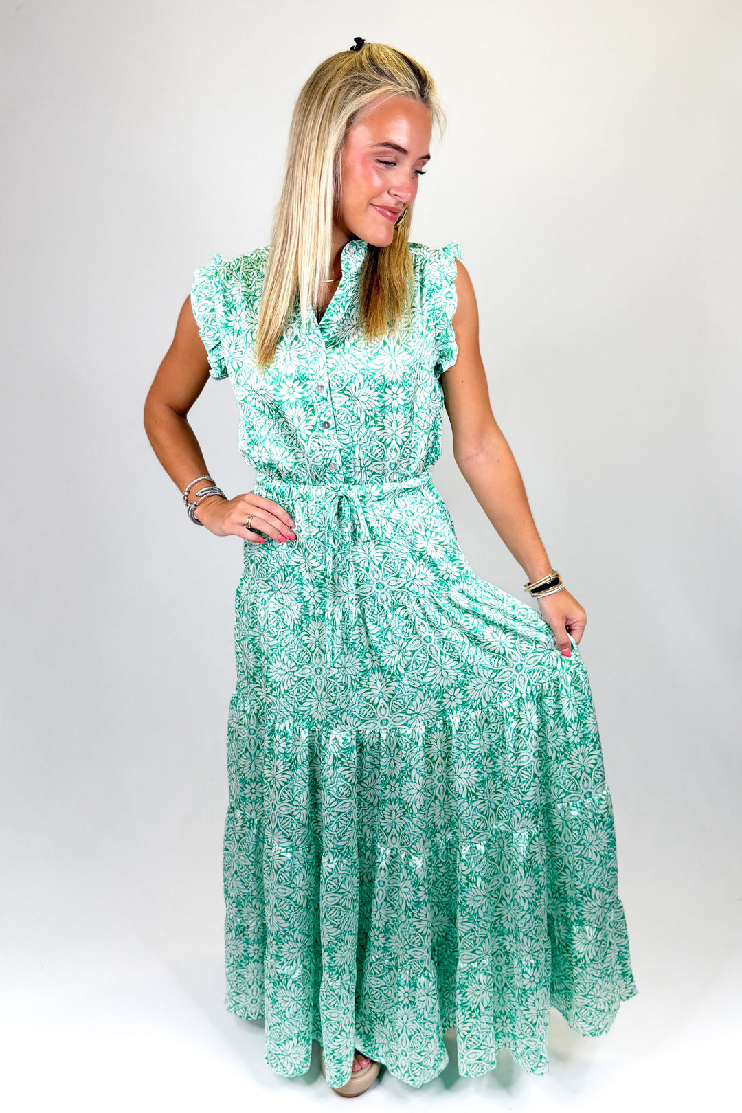 Woman wearing a green floral dress on a white background