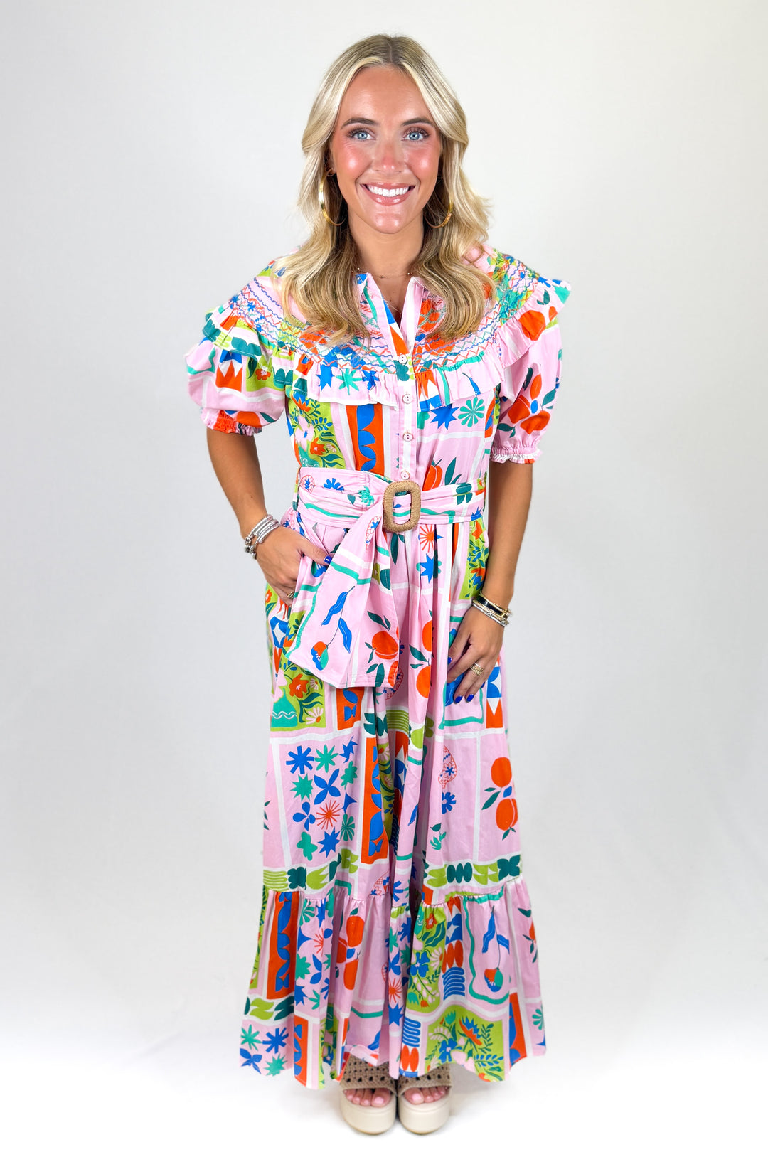 Woman wearing a colorful dress with a white background